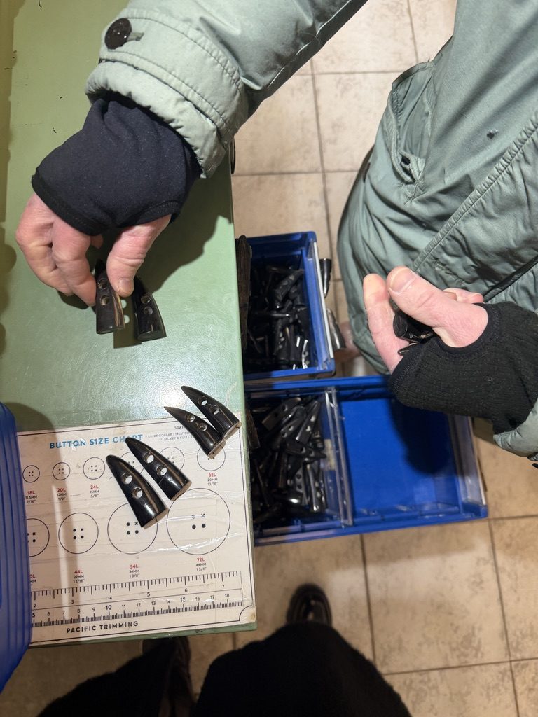 Choosing buttons by hand at the trimming supplier